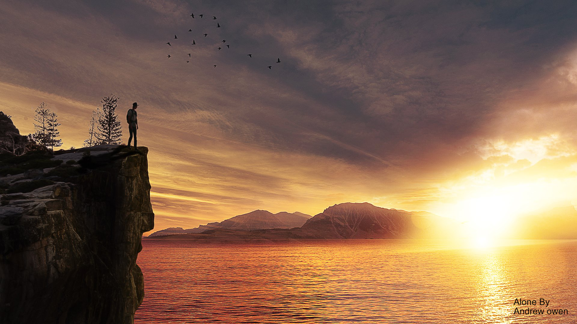 alone. a man standing on a cliff